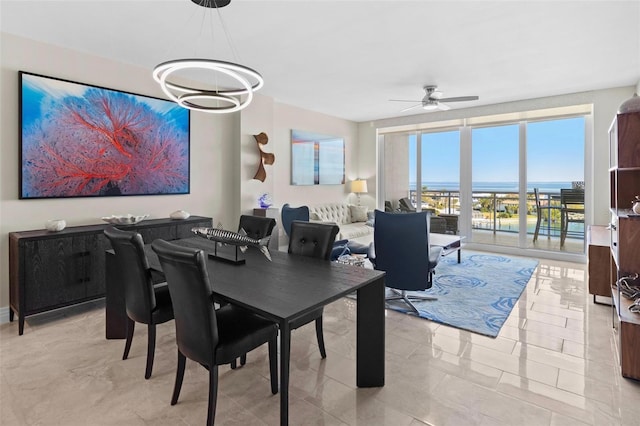 1325 Snell Isle Blvd NE Unit 708, Saint Petersburg, FL 33704 - dining room with a ceiling fan, a chandelier, and light marble finish flooring