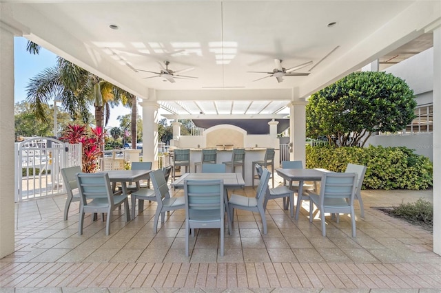1325 Snell Isle Blvd NE Unit 708, Saint Petersburg, FL 33704 - view of patio with outdoor dining area, a ceiling fan, and an outdoor kitchen