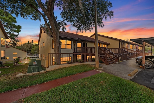 7741 Forest Trl Unit 6, Port Richey, FL 34668 - back of property at dusk featuring a yard