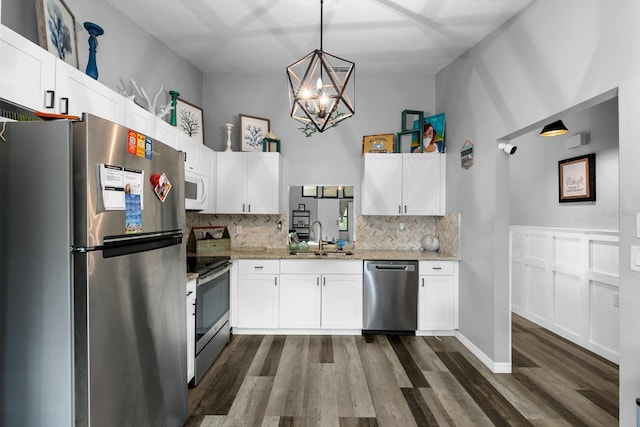 7741 Forest Trl Unit 6, Port Richey, FL 34668 - kitchen featuring stainless steel appliances, a sink, decorative backsplash, dark wood-type flooring, and a chandelier