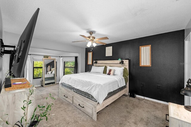 7741 Forest Trl Unit 6, Port Richey, FL 34668 - bedroom featuring light colored carpet, baseboards, a ceiling fan, a textured ceiling, and access to exterior