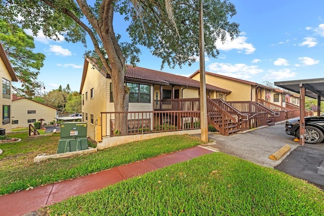 7741 Forest Trl Unit 6, Port Richey, FL 34668 - view of front of property with stucco siding, a front lawn, and parking