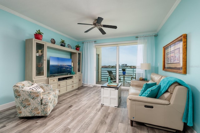 7932 Sailboat Key Blvd S Unit 506, South Pasadena, FL 33707 - living room with ornamental molding, light wood-style flooring, ceiling fan, and baseboards