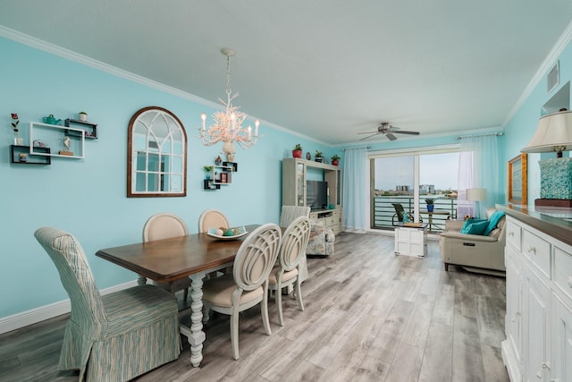 7932 Sailboat Key Blvd S Unit 506, South Pasadena, FL 33707 - dining space with crown molding, light wood-type flooring, a ceiling fan, a chandelier, and baseboards