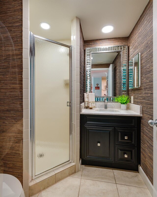 7932 Sailboat Key Blvd S Unit 506, South Pasadena, FL 33707 - full bathroom featuring tile patterned floors, a shower stall, vanity, and toilet
