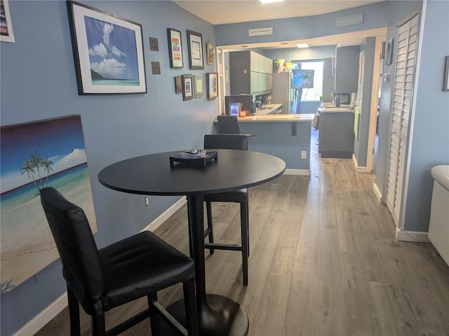 4705 NE 1st St NE Unit 327, Saint Petersburg, FL 33703 - dining area with wood finished floors and baseboards