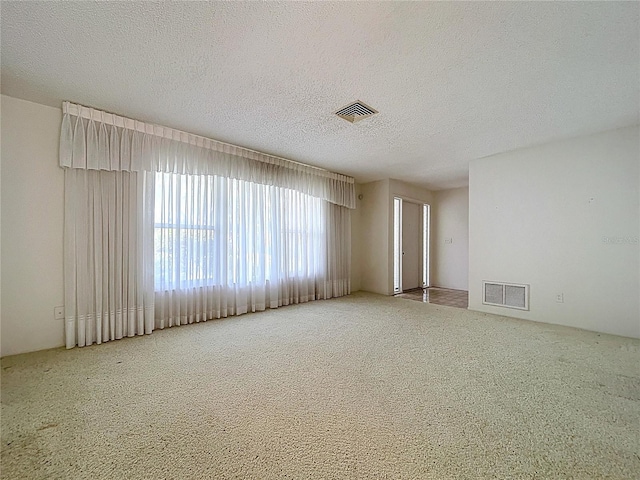 13725 Oak Forest Blvd N, Seminole, FL 33776 - carpeted spare room with a textured ceiling