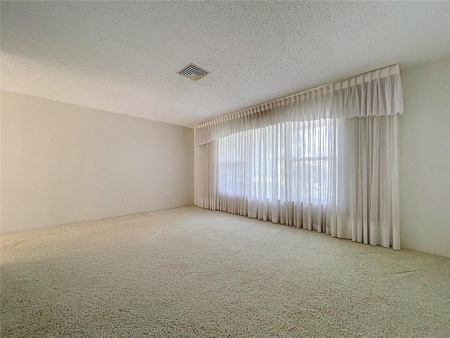 13725 Oak Forest Blvd N, Seminole, FL 33776 - unfurnished room featuring carpet floors and a textured ceiling