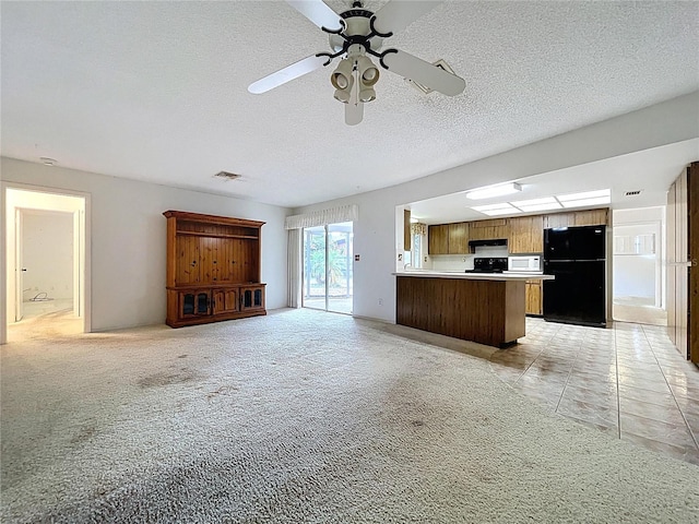 13725 Oak Forest Blvd N, Seminole, FL 33776 - unfurnished living room featuring ceiling fan and a textured ceiling