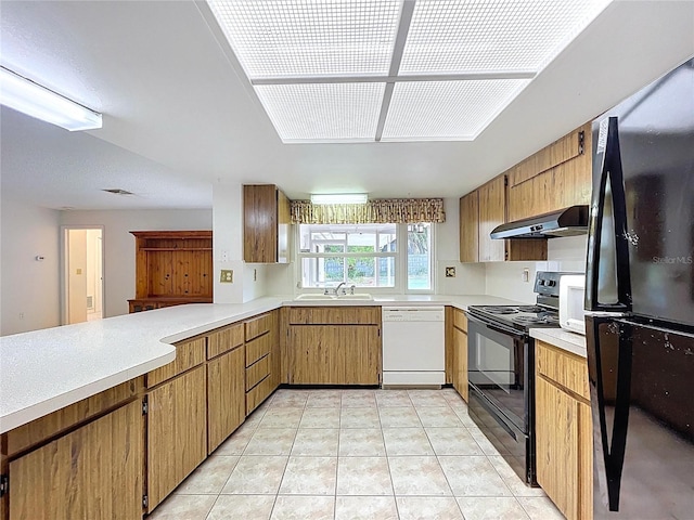 13725 Oak Forest Blvd N, Seminole, FL 33776 - kitchen with black appliances, under cabinet range hood, a sink, and light countertops