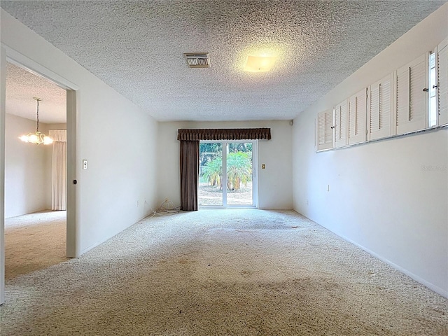 13725 Oak Forest Blvd N, Seminole, FL 33776 - unfurnished room featuring carpet flooring, a chandelier, and a textured ceiling