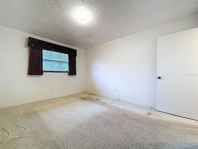 13725 Oak Forest Blvd N, Seminole, FL 33776 - carpeted spare room with a textured ceiling