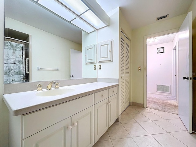 13725 Oak Forest Blvd N, Seminole, FL 33776 - full bath with vanity, tile patterned flooring, and a closet