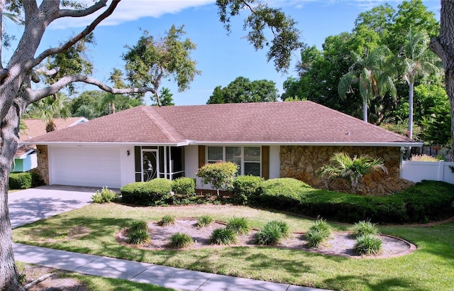 13725 Oak Forest Blvd N, Seminole, FL 33776 - single story home featuring stone siding, a garage, and concrete driveway