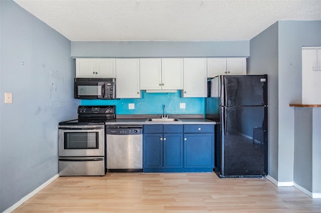 8220 12th Way N Unit G, Saint Petersburg, FL 33702 - kitchen featuring black appliances, a sink, light wood finished floors, white cabinetry, and a textured ceiling