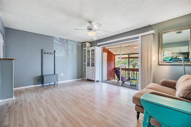 8220 12th Way N Unit G, Saint Petersburg, FL 33702 - living area with wood finished floors, ceiling fan, a textured ceiling, and baseboards