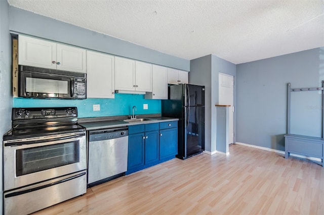 8220 12th Way N Unit G, Saint Petersburg, FL 33702 - kitchen featuring black appliances, light wood-style flooring, a sink, white cabinetry, and a textured ceiling