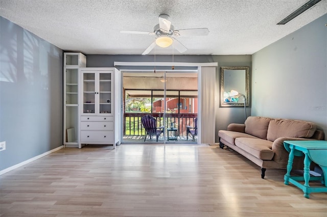 8220 12th Way N Unit G, Saint Petersburg, FL 33702 - living area with a ceiling fan, wood finished floors, and a textured ceiling