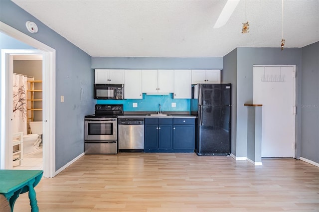 8220 12th Way N Unit G, Saint Petersburg, FL 33702 - kitchen featuring black appliances, light wood-type flooring, a sink, white cabinetry, and a textured ceiling