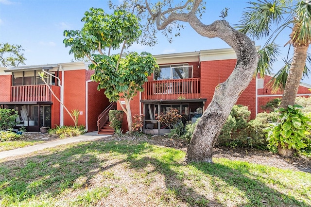 8220 12th Way N Unit G, Saint Petersburg, FL 33702 - view of front of property with a sunroom, brick siding, and stairway