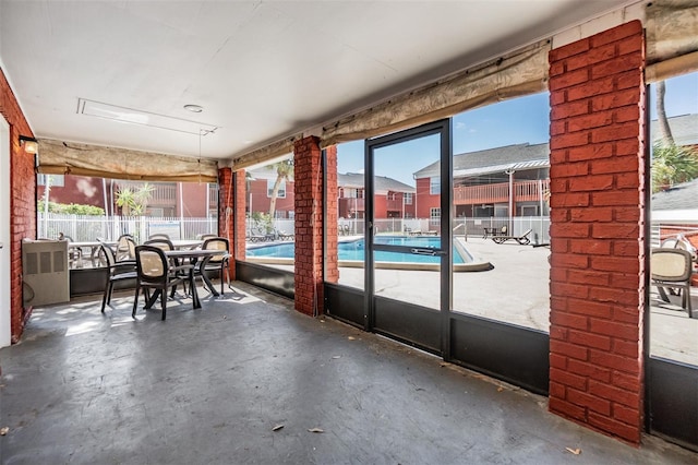8220 12th Way N Unit G, Saint Petersburg, FL 33702 - sunroom featuring healthy amount of natural light and outdoor dining area