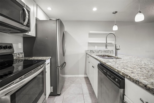 2581 Countryside Blvd Unit 2309, Clearwater, FL 33761 - kitchen with appliances with stainless steel finishes, a sink, white cabinetry, light stone counters, and pendant lighting