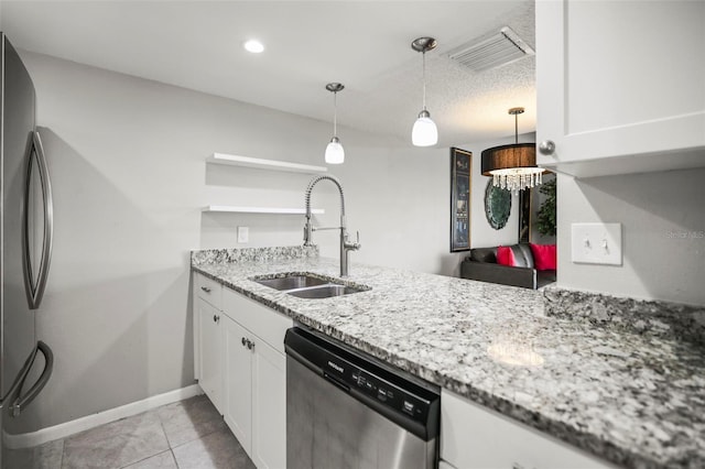 2581 Countryside Blvd Unit 2309, Clearwater, FL 33761 - kitchen with appliances with stainless steel finishes, a sink, white cabinets, baseboards, and light stone counters