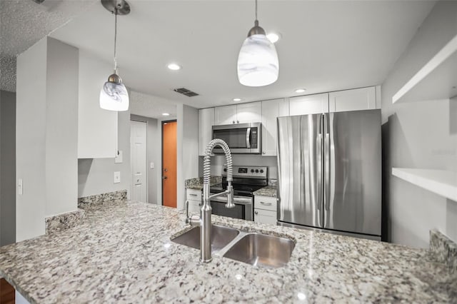 2581 Countryside Blvd Unit 2309, Clearwater, FL 33761 - kitchen featuring stainless steel appliances, white cabinetry, light stone counters, recessed lighting, and a sink