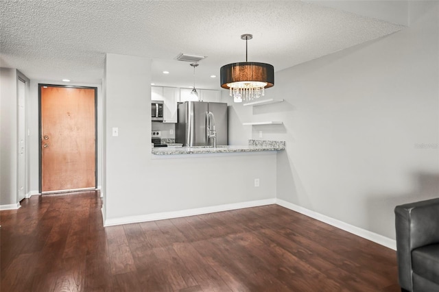 2581 Countryside Blvd Unit 2309, Clearwater, FL 33761 - kitchen with stainless steel appliances, dark wood finished floors, a textured ceiling, hanging light fixtures, and recessed lighting