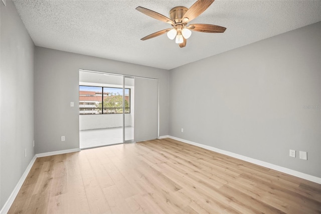 2581 Countryside Blvd Unit 2309, Clearwater, FL 33761 - empty room with a ceiling fan, light wood finished floors, a textured ceiling, and baseboards