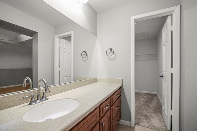 2581 Countryside Blvd Unit 2309, Clearwater, FL 33761 - bathroom with vanity, a spacious closet, and baseboards