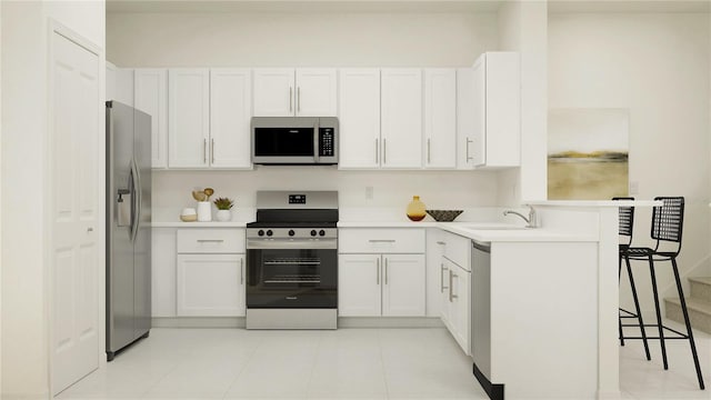 234 SE 27th St, Ruskin, FL 33570 - kitchen featuring appliances with stainless steel finishes, a sink, a kitchen breakfast bar, white cabinetry, and light countertops