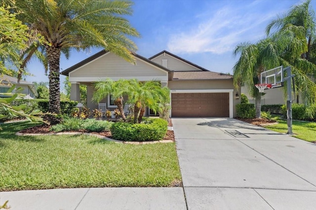 32193 Watoga Loop, Wesley Chapel, FL 33543 - view of front facade with a garage, driveway, a front yard, and stucco siding