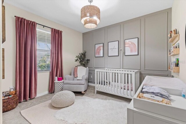 32193 Watoga Loop, Wesley Chapel, FL 33543 - bedroom featuring carpet, a nursery area, and a decorative wall