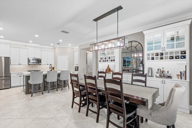 32193 Watoga Loop, Wesley Chapel, FL 33543 - dining area featuring ornamental molding, recessed lighting, light tile patterned floors, and a textured ceiling