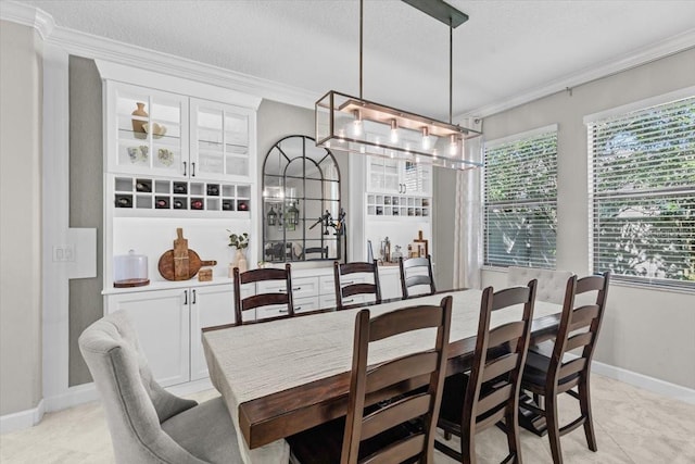 32193 Watoga Loop, Wesley Chapel, FL 33543 - dining area featuring ornamental molding, a chandelier, a textured ceiling, and light tile patterned floors