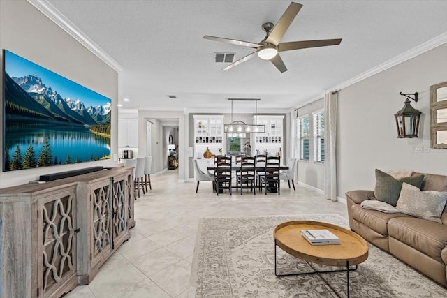 32193 Watoga Loop, Wesley Chapel, FL 33543 - living area featuring ceiling fan, crown molding, light tile patterned floors, and a textured ceiling