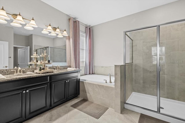 32193 Watoga Loop, Wesley Chapel, FL 33543 - bathroom with double vanity, a stall shower, a garden tub, and tile patterned flooring
