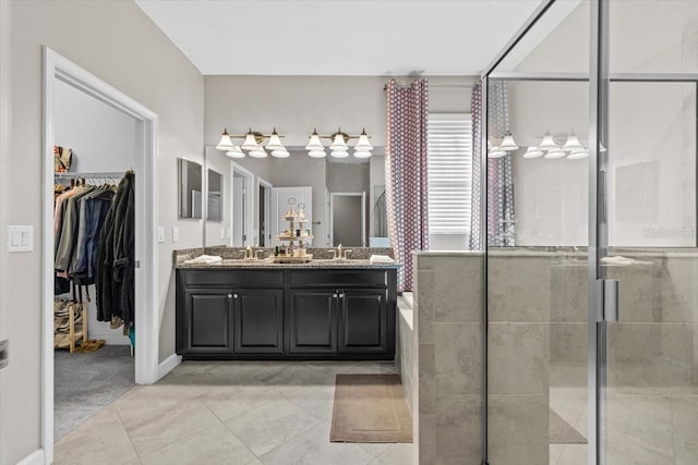 32193 Watoga Loop, Wesley Chapel, FL 33543 - full bathroom featuring double vanity, a shower stall, a spacious closet, tile patterned flooring, and a bathtub