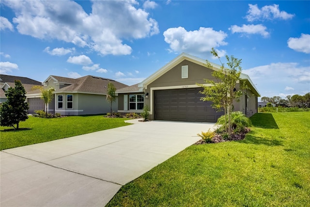 16508 66th Ln E, Parrish, FL 34219 - single story home with driveway, a garage, stucco siding, and a front lawn