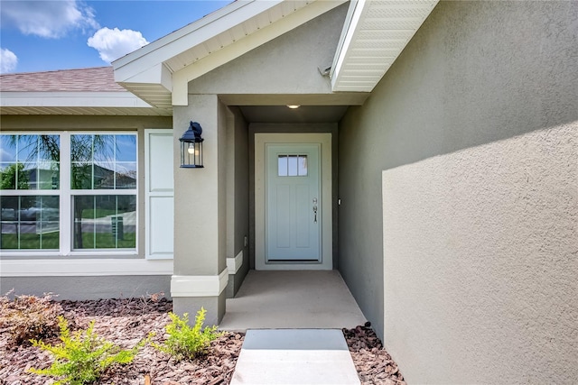 16508 66th Ln E, Parrish, FL 34219 - property entrance with stucco siding and a shingled roof