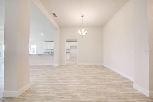 16508 66th Ln E, Parrish, FL 34219 - unfurnished dining area featuring a chandelier, baseboards, and light wood-style floors