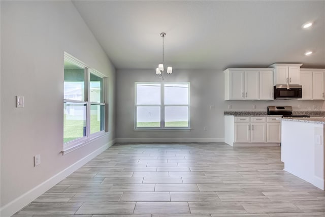 16508 66th Ln E, Parrish, FL 34219 - kitchen featuring stainless steel appliances, recessed lighting, baseboards, white cabinets, and light stone counters
