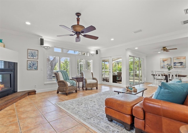 715 45th Ave NE, Saint Petersburg, FL 33703 - living room featuring a ceiling fan, light tile patterned floors, crown molding, recessed lighting, and a glass covered fireplace