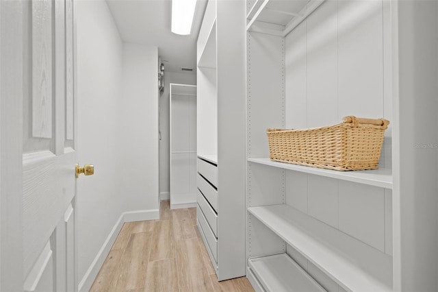 715 45th Ave NE, Saint Petersburg, FL 33703 - walk in closet featuring light wood finished floors