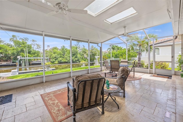 715 45th Ave NE, Saint Petersburg, FL 33703 - sunroom / solarium featuring ceiling fan, outdoor dining space, a skylight, and healthy amount of natural light