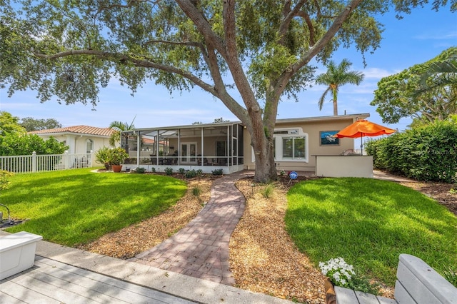 715 45th Ave NE, Saint Petersburg, FL 33703 - rear view of house featuring stucco siding and a sunroom