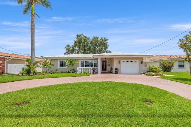 715 45th Ave NE, Saint Petersburg, FL 33703 - ranch-style home featuring decorative driveway, stucco siding, a garage, and a tiled roof