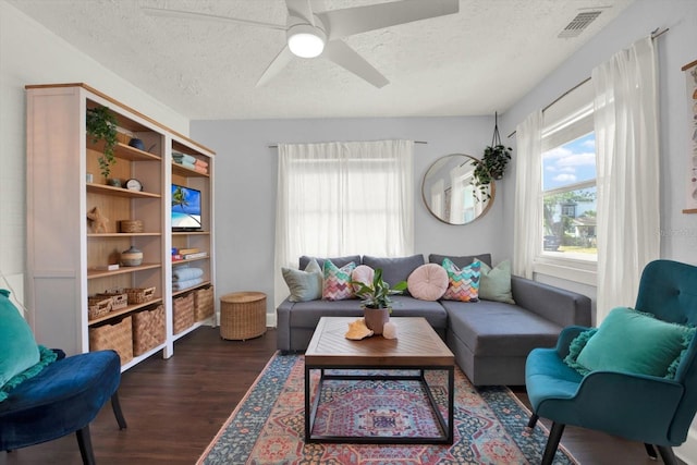 3230 4th Ave S, Saint Petersburg, FL 33712 - living area with a textured ceiling, dark wood-style flooring, and a ceiling fan