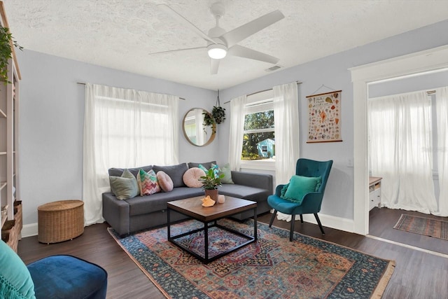 3230 4th Ave S, Saint Petersburg, FL 33712 - living room featuring a textured ceiling, wood finished floors, a ceiling fan, and baseboards